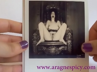 Aragne displays her polaroids from a